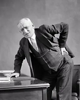 Sore: Senior Man Grimacing Facial Expression Holding