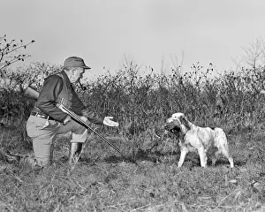 Shotguns: Senior Man Hunter with Shotgun Kneeling Taking