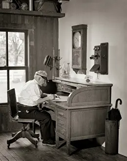 Kerosene: Senior Man Wearing Visor Sitting in Office at
