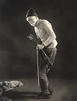 Woolen: Senior man in woolen cap holding a violin