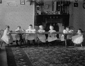 Orphanages: Seven toddlers sit at a table at the Childrens