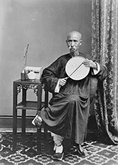 Shaven: Shaven-headed man with pipe and fan, China