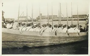 Sepia Images: Ship's crew in rowing boat with oars held vertically