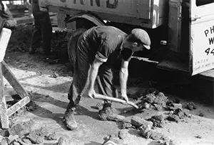 Bends: Shovelling rubble onto a lorry