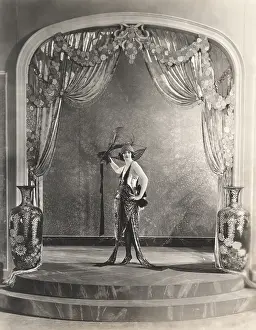 Urns: Showgirl posing under archway