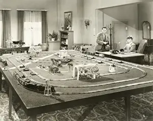 Businesswoman: Showing off new toy train set -