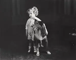 Preschool: Shy little boy standing with his dog