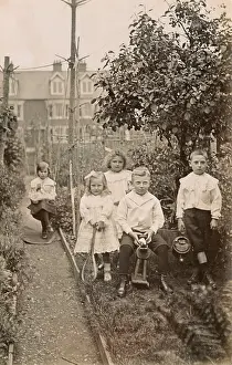 Five siblings playing in their suburban garden
