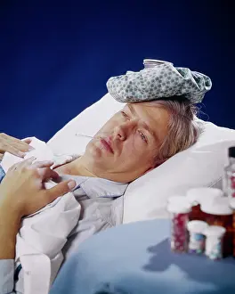 Impairment: Sick Man Patient Lying in Bed Ice Bag on Top of
