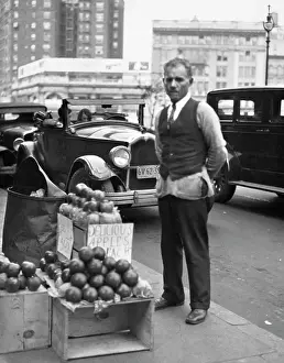 Businesspeople: Sidewalk Apple Vendor Man Looking at Camera During the Gre