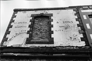 Bricked: Sign on derelict building with bricked-in window