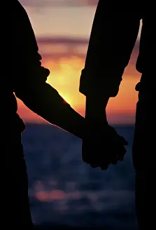 Lga001: Silhouette of Anonymous Couple Holding Hands Sunset