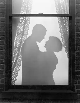 Infatuated: Silhouette of a couple embracing