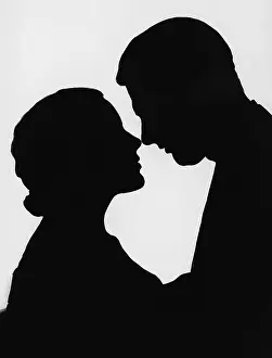 Desirable: Silhouette of couple about to kiss