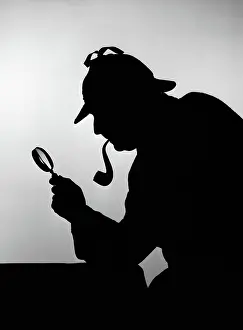 Silhouette of sherlock holmes holding magnifying