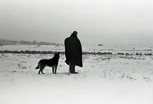 Surroundings: Silhouetted figure of a man and his dog
