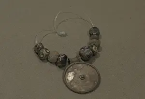 Bead: Silver medallion and faience eye beads