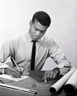 Drafting: Single African-American Man Engineer Working Reviewing