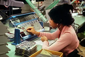 Laboring: Single African-American Woman Worker Assembling