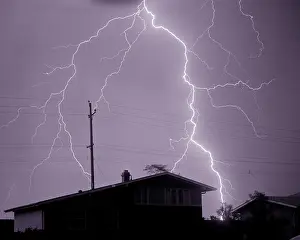 Electrostatic: Single Lightning Bolt Discharge in Sky Over Dark