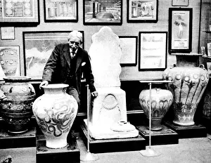 Sir Arthur Evans arranging exhibits, Burlington House, Londo
