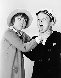 Sibling: Sister pretending to strangle her brother