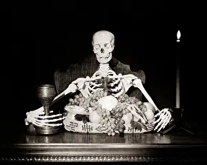 Spook: A Skeleton Seated at Dining Table Before Large