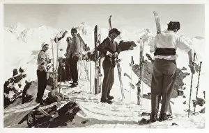 Downhill: Skiers on top of a show covered mountain