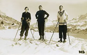 Downhill: Skiers on top of a show covered mountain