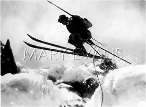 Skiier: SKIING OVER A CREVASSE
