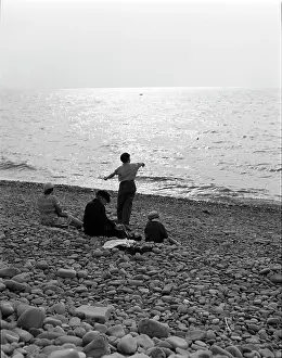 Skimming: Skimming stones on a pebble beach
