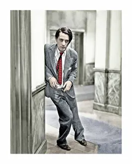 Dado: Skinny man leaning against a wall
