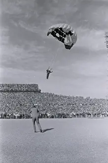 Skydiver: A skydiver, one of a team of three, prepares to