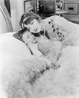 Affections: Sleeping child is being hugged by its mother