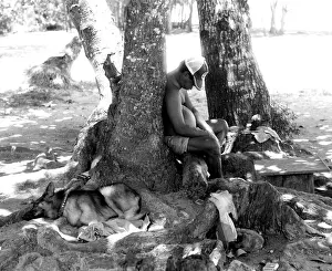 The Japics Historic Image Collection: Sleeping man with dog, La Digue, Seychelles