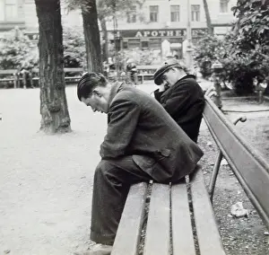 Tiredness: Sleeping men on a bench