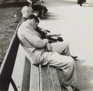 Tiredness: Sleeping men on a bench in a park