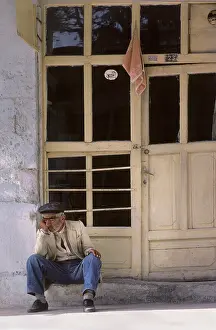 Dozing: Sleeping old man on doorstep, Turkey