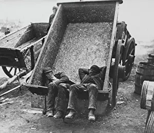 Exhausting: Sleeping workmen in a cart