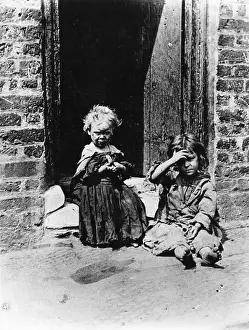 Town & Country Planning: Slum children sitting in a doorway
