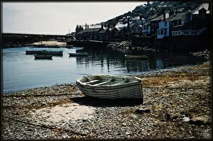 Mousehole: A small boat moored in Mousehole Harbour, beached