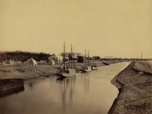 Ismailia: Small boats moored at water's edge to the ?