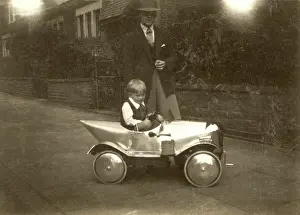 Chrome: Small boy with chrome shiny silver pedal car