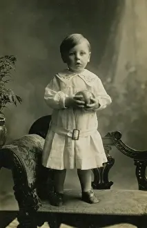 Belle Elise Collection: Small boy standing on chaise-longue
