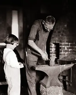 Grandparent: Small Boy Watching a Man Working on Blacksmith'S