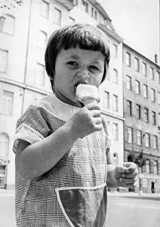 Ices: Small child eats an ice cream