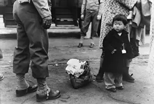 Apprehensively: Small child looks apprehensively at the ?