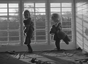 Creche: Two small children with teddy bears in a nursery