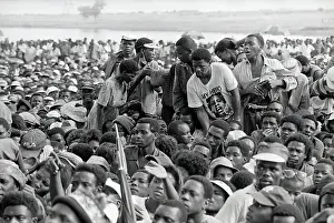 Hani: A small group stand in the midst of a seated crowd
