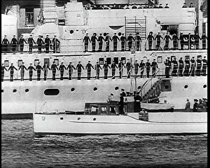 Motorboat: A Small Motorboat Driving Past a Warship